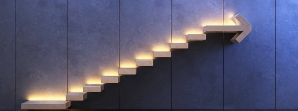 lit up stairs with arrow pointing upwards