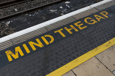 image of pavement with mind the gap text written on it