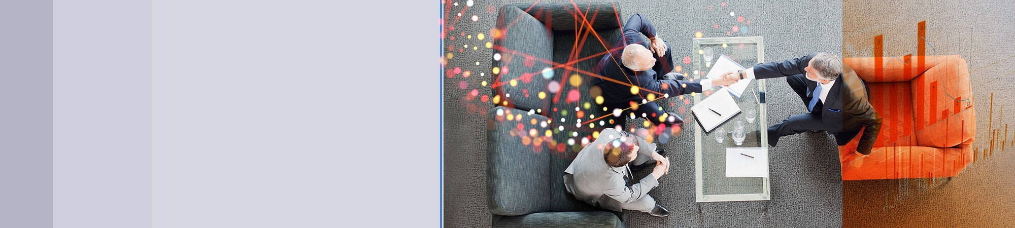 A top-down view of three suited professionals seated around a small table, shaking hands; abstract coloured lines overlay the meeting scene.